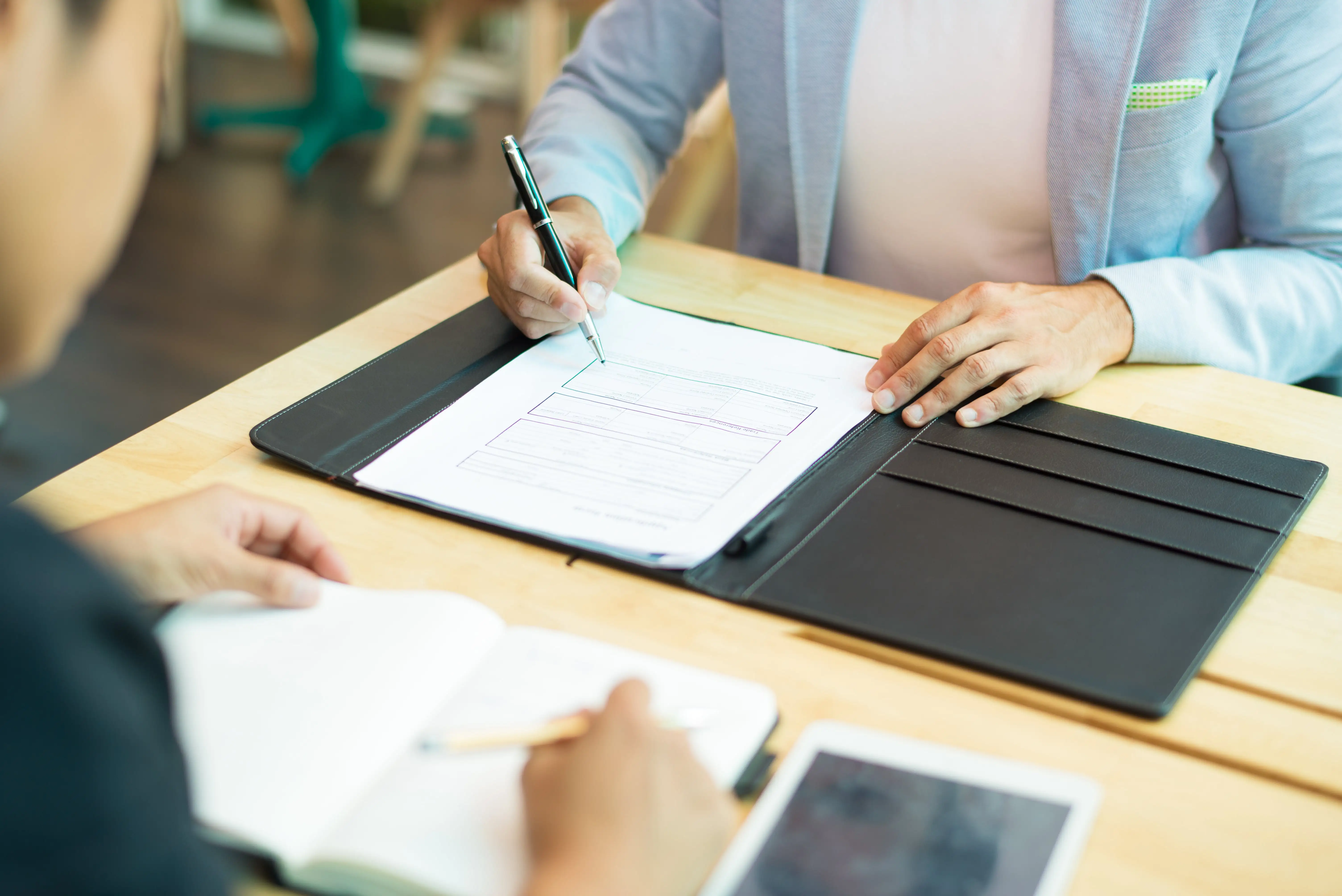 Businessman filling out a contract document